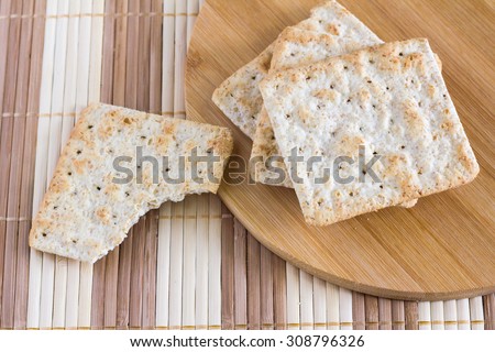square wheat crackers Snack on wooden mat