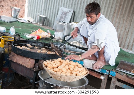JAIPUR, INDIA - FEBRUARY 04: Cooking indian. Hindu man preparing food for a traditional wedding ceremony on February 04, 2014. Jaipur, India.