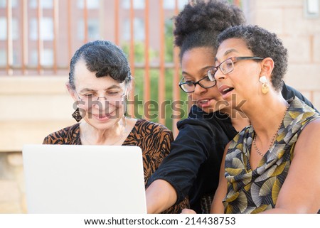 Closeup portrait, multigenerational family looking at something exciting on laptop, isolated outdoors background
