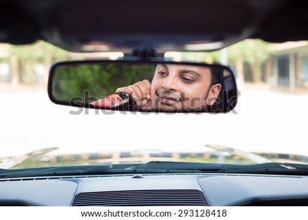 Closeup portrait, young guy drinking alcoholic beverage stoned, under the influence,  isolated interior car windshield background. A menace driver to the road