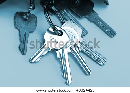Bunch of keys isolated over blue background