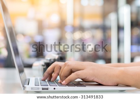 A woman hands typing on a laptop.