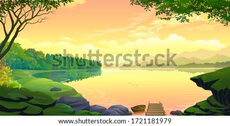 A sunset view of a lake with mountains and the orange skies.