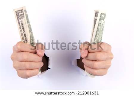 Woman two hand with dollars through a hole in paper isolated on white