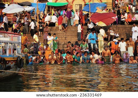 VARANASI,INDIA - OCTOBER 23: Hindu pilgrims take holy bath in the river Ganga on the Diwali festival on October 23, 2014 in Varanasi, Uttar Pradesh, India.
