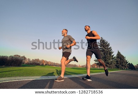 Similar – Foto Bild Sportler laufen auf Asphaltstrasse in den Bergen