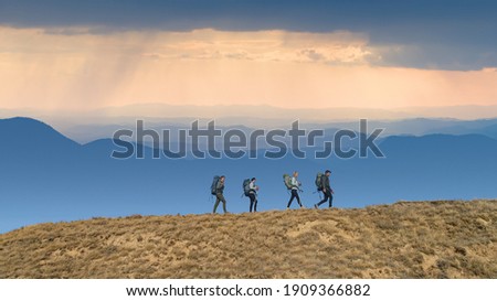 Similar – Image, Stock Photo Four people hiking with fog