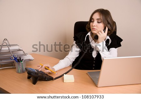 Businesswoman with telephone sitting at  the chair at office