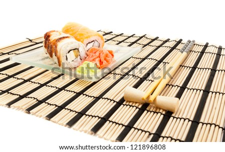 Maki sushi with wasabi on bamboo sushi mat isolated