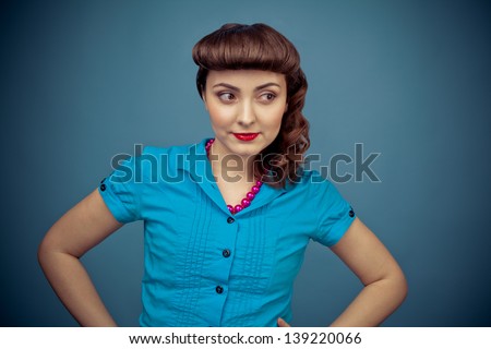 Beautiful woman with retro hairstyle on blue background