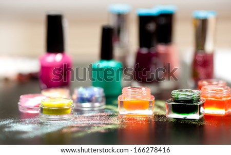 Colorful powder for nails on black background