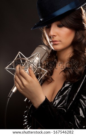 Picture of beautiful singer with studio microphone
