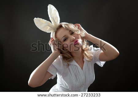 Blond woman with rabbit\'s ears woman with rabbit\'s ears sending a kiss