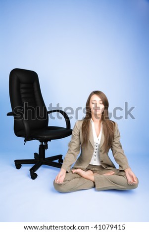 Young woman in costume sitting in lotus pose and meditating