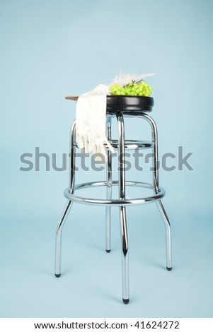 Bar chair with gloves, grapes and fan