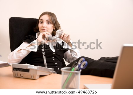 Bussinesswoman with telephone sitting at  the chair at office