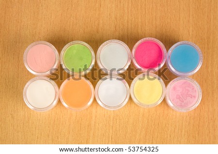 Colorful powder for nails on the desk