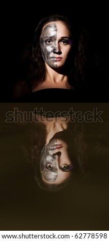 Two-faced girl with reflection on the black background