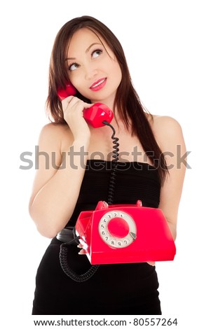 Girl with old red telephone talking isolated on white