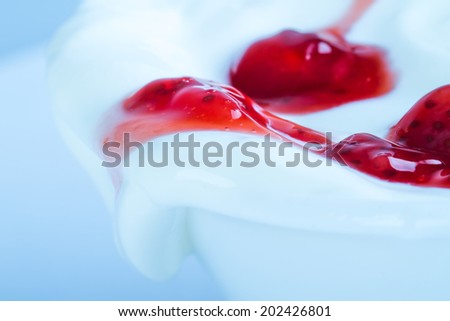 Spilled yogurt with strawberry or raspberry marmalade.
