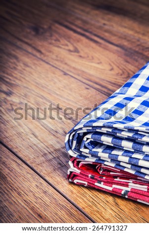 Top view of checkered napkin on wooden table. Free space for your creative information