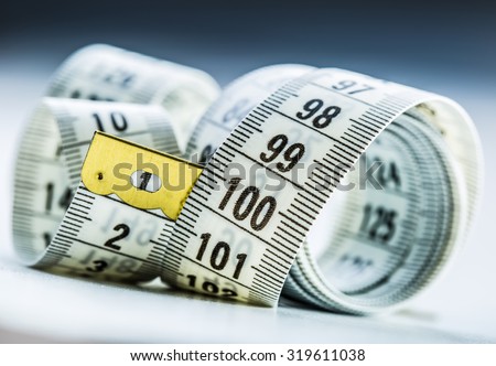 Curved measuring tape. Measuring tape of the tailor. Closeup view of white measuring tape