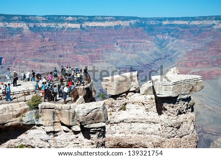 GRAND CANYON, ARIZONA - SEPTEMBER 30: Tourist looking at south rim of Grand Canyon on September 30, 2011 in Arizona, USA. Grand Canyon is 277 miles (446 km) long, up to 18 miles (29 km) wide.