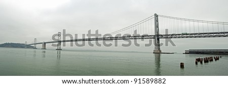 Suspension Oakland Bay Bridge in San Francisco to Yerba Buena Island in foggy weather with downtown