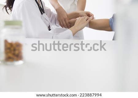 Physician administering the treatment to the patient\'s arm