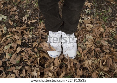 Feet of children and fallen leaves