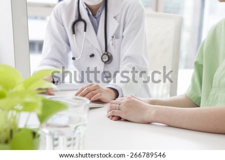 Doctor talking to her woman patient at office