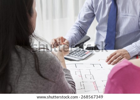 Real estate agent showing a construction project to a woman