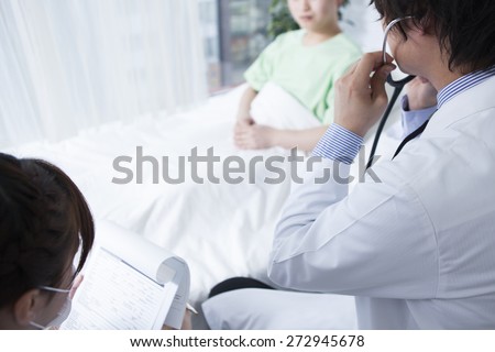 Male nurse or doctor listening with stethoscope to patient\'s heart and lungs
