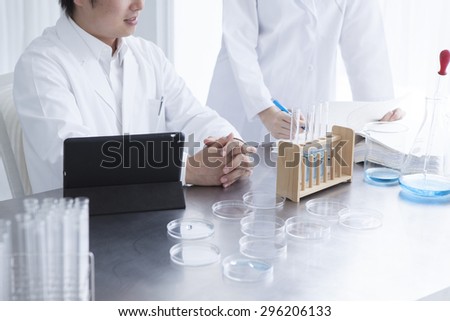 Science student looking at tablet pc in the lab at the university