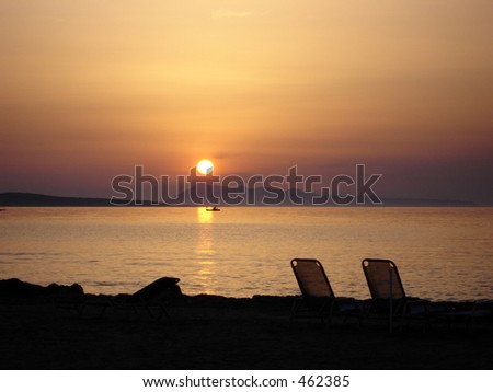 Beautiful sunset over ocean, with boat in the distance