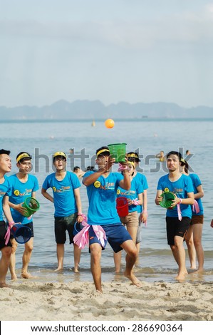 16 June 2014 in Halong bay Vietnam, unknown name staff of Mobile World JSC play team building game at sea side. Mobile World JSC is a big group retailers of electronics in Vietnam