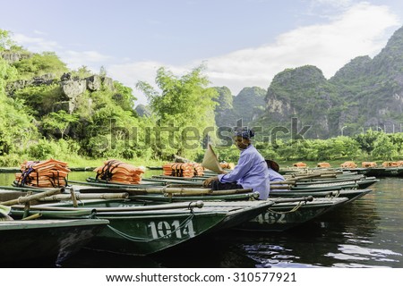 TRANGAN TOURIST, VIETNAM - JUNE 28, 2015 - boatwoman waiting guest. This is a UNESCO site and very famous for its beauty of caves, temples & natural beauty.