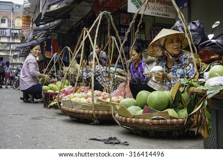 Hanoi, Vietnam, April 28, 2015: Street vendors selling in sidewalks on the street