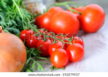 Vegetable groceries on the table - tomatoes, cherry tomatoes and lettuce - selective focus