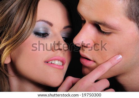 Attractive young couple in the moment just before they kiss