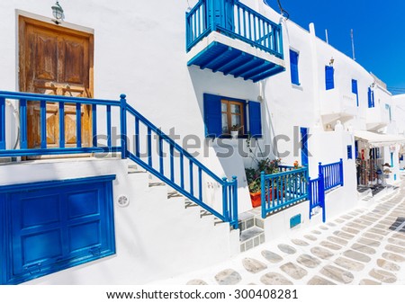 Mykonos old town street with cobbled walkways, white walls, and painted door and windows, Mykonos island, Greece