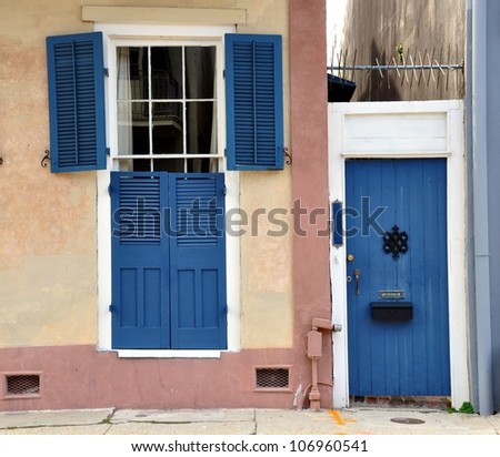 Blue Shuttered Entry Door And Gated Alley Of A New Orleans French Quarter Residence