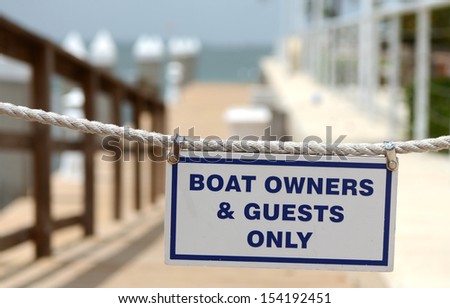 Boat Owners And Guests Only Sign Hung Across Entrance to Pier