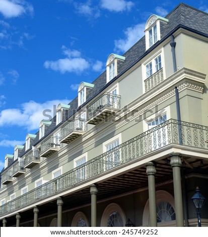 New Orleans French Quarter Architecture With Balcony Against Blue Sky With White Clouds