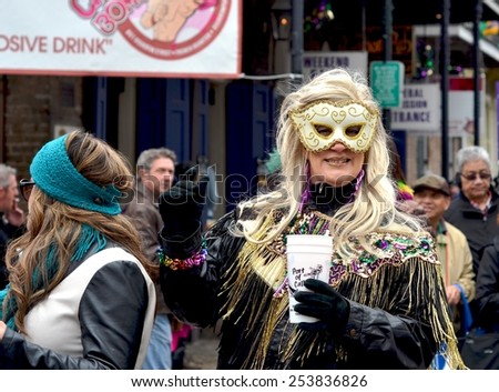 NEW ORLEANS, LA-FEBRUARY 17:  Masked revelers and party-goers parade through the streets of the New Orleans French Quarter in costumes on Mardi Gras Day, Tuesday, February 17, 2015.