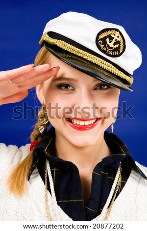 Smiling blond young woman saluting in a sea peak-cap
