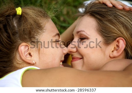 Happy mom and daughter smiling outdoors