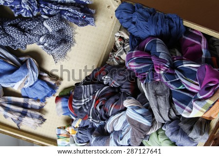 Suitcase with summer scarves, summer scarves in suitcases, a suitcase full of men scarves