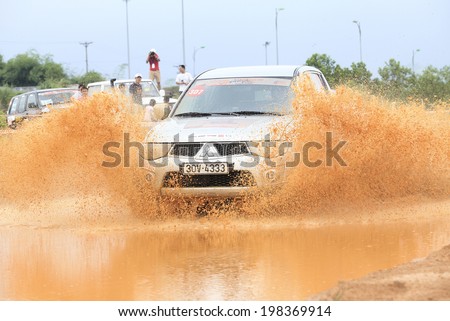 HANOI, VIETNAM - JUNE 8, 2014: Unidentified SUV doing an circuit of Vietnam Off-road Cup (VOC) in a water road area of Hanoi. VOC is an yearly event for off-road player in Vietnam.
