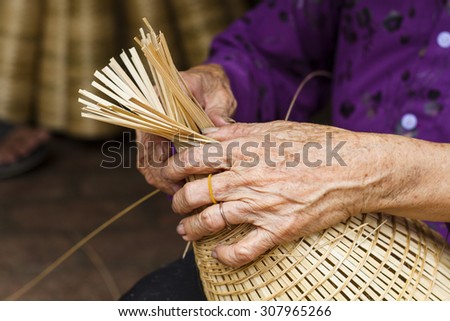 The woman\'s hand to make bamboo fish trap from bamboo material, clever hand and hard working to make product in Vietnam.